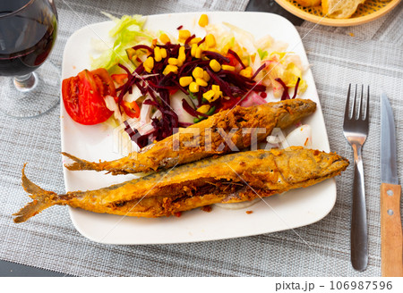 Fried scomber with chopped vegetables 106987596