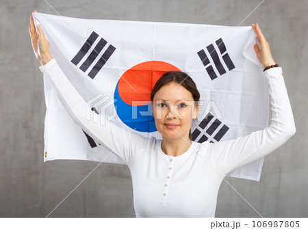 Happy woman posing with national flag of South Korea Happy woman posing with national flag of South Korea 106987805