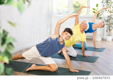 Family of three people practice yoga Family of three people practice yoga 106987855