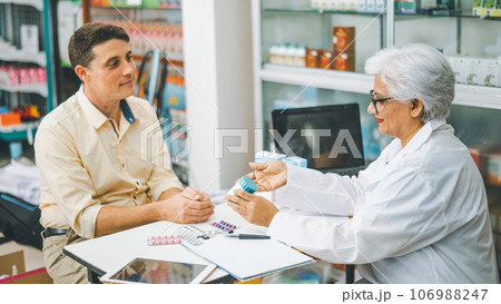 Pharmacist giving advice And advice for patients who come to buy Medicine, Drugs, Vitamins products, according to prescriptions in modern pharmacies. 106988247
