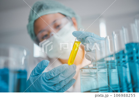 Female researchers are experimenting with pipette dropping a sample into a test tube in an experiment research in laboratory... Female researchers are experimenting with pipette dropping a sample into a test tube in an experiment research in laboratory... 106988255
