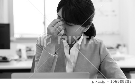 疲れを感じる女性会社員モノクロイメージ 106989885