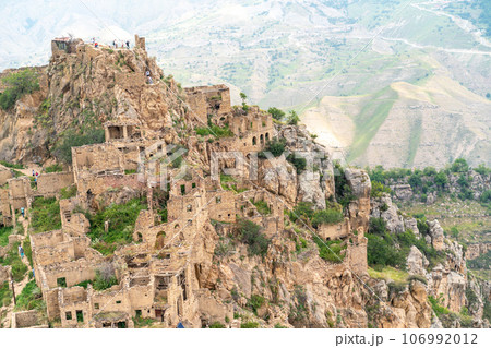 Dagestan Gamsutl. Ancient ghost town of Gamsutl old stone houses in abandoned Gamsutl mountain village in Dagestan, Abandoned etnic aul, summer landscape. 106992012