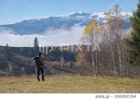 Photographer hiker taking picture of nature with digital camera Photographer hiker taking picture of nature with digital camera 106992164