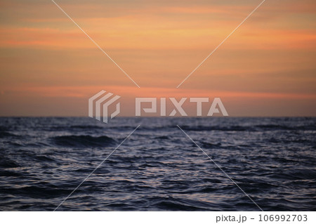 Dramatic red ocean waves at sunset with soft evening sea dark water 106992703