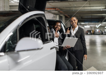 Coworkers discussing issues via laptop in EV in basement 106992807