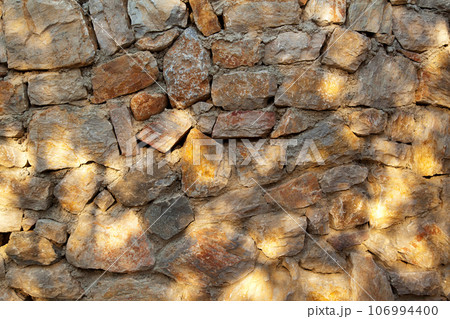 Sturdy yellow and beige cut stone wall made in Datca, Turkey, seamless lined up Sturdy yellow and beige cut stone wall made in Datca, Turkey, seamless lined up 106994400