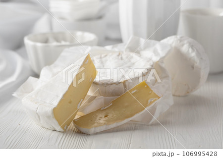 Camembert cheese on a white wooden table. 106995428