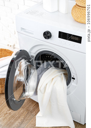 Washing machine and basket in a laundry room Washing machine and basket in a laundry room 106996701