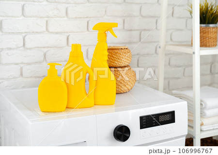 Laundry washing detergents containers on washing machine 106996767