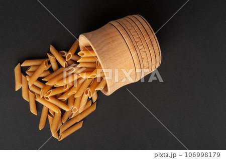 Raw Brown Pasta, Wholegrain Penne, Dry Whole Grain Noodle, Raw Spelt Macaroni, Healthy Italy Food Raw Brown Pasta, Wholegrain Penne, Dry Whole Grain Noodle, Raw Spelt Macaroni, Healthy Italy Food 106998179
