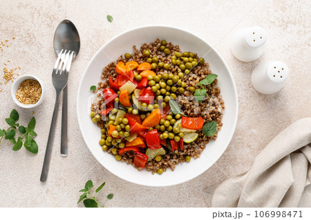 Buckwheat with roasted vegetables and green peas 106998471