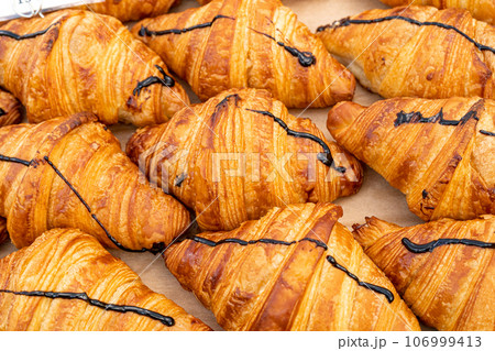 Many Croissant at Street Market, Fresh Puff Pastry Pies, Sweet Kipferls, Buttery Chocolate-Nutty Viennoiseries 106999413