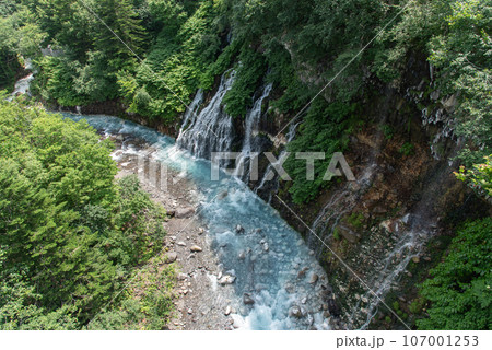青く色づいた滝と川 107001253