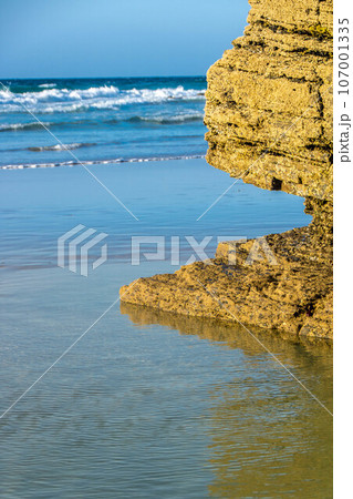 beautiful beach with blue sea and rocks 107001335