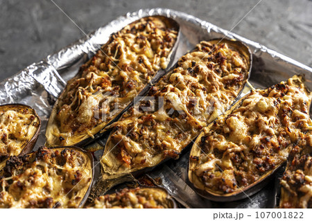 eggplant baked with meat on a baking sheet 107001822