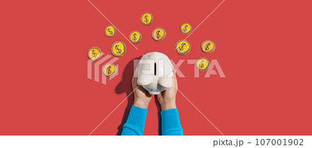 Person holding piggy bank with hand drawn coins 107001902