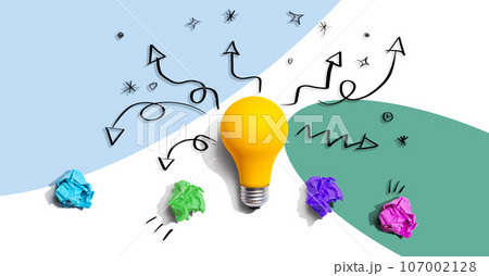Brainstorming concept with a idea light bulb and crumpled paper 107002128