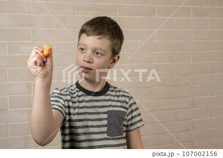 boy of school age writes in the air with an orange marker boy of school age writes in the air with an orange marker 107002156