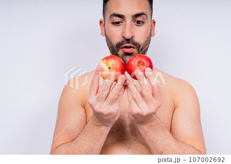 Man, hands and holding apple on white background in studio for health, wellness or immune support. Man, hands and holding apple on white background in studio for health, wellness or immune support. 107002692