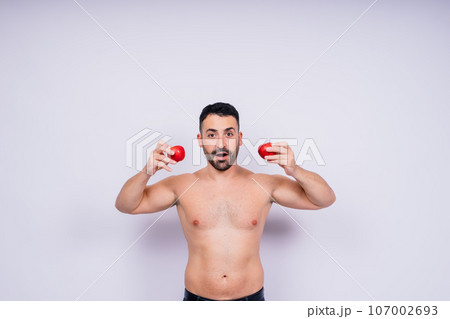 Man, hands and holding apple on white background in studio for health, wellness or immune support. Man, hands and holding apple on white background in studio for health, wellness or immune support. 107002693