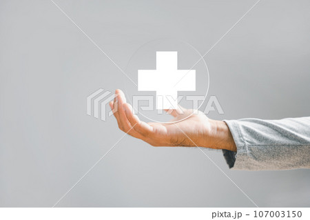 Hand of a businessman holds a plus sign, symbolizing positivity, benefits, personal development, social network. Emphasizes value addition and incentives in a corporate context. Hand of a businessman holds a plus sign, symbolizing positivity, benefits, personal development, social network. Emphasizes value addition and incentives in a corporate context. 107003150