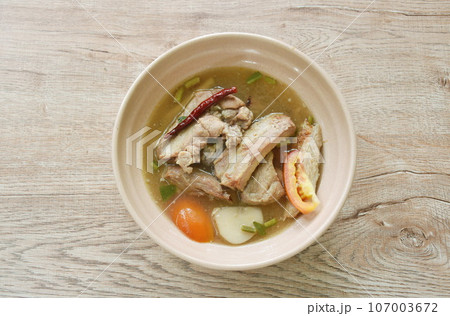 hot and spicy pork bone with tamarind and Thai herbs soup on bowl  107003672