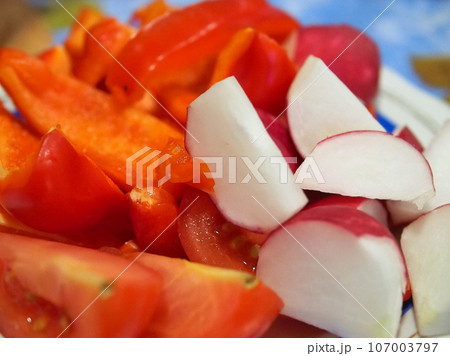 Vegetable still life, fresh tomatoes, peppers and radishes, close-up. Vegetable still life, fresh tomatoes, peppers and radishes, close-up. 107003797