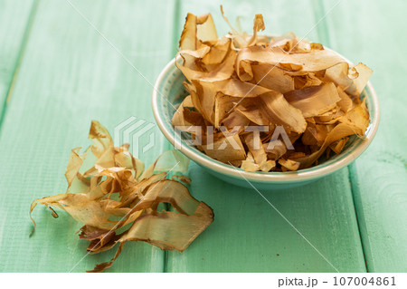 Bonito flakes on rustic background, direct sun light Bonito flakes on rustic background, direct sun light 107004861