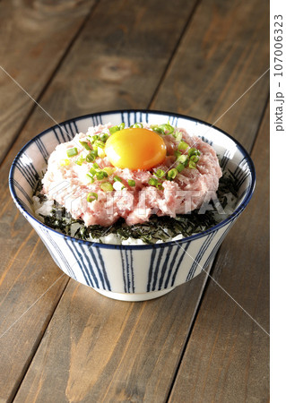 刻み海苔と卵黄とネギトロの丼ぶりを単品撮影 107006323