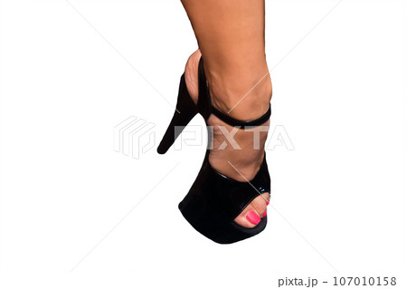 Female foot in black stilettos, high-heeled heels on white background, isolated Female foot in black stilettos, high-heeled heels on white background, isolated 107010158