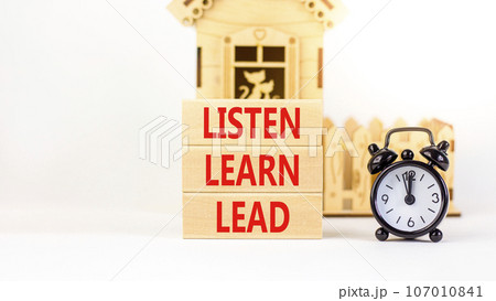 Listen learn lead symbol. Concept word Listen Learn Lead on beautiful wooden block. Black alarm clock. Beautiful white table white background. Business, education listen learn lead concept. Copy space Listen learn lead symbol. Concept word Listen Learn Lead on beautiful wooden block. Black alarm clock. Beautiful white table white background. Business, education listen learn lead concept. Copy space 107010841