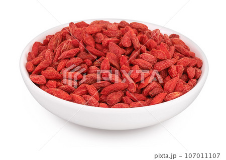 Dried goji berries in ceramic bowl isolated on white background with full depth of field Dried goji berries in ceramic bowl isolated on white background with full depth of field 107011107