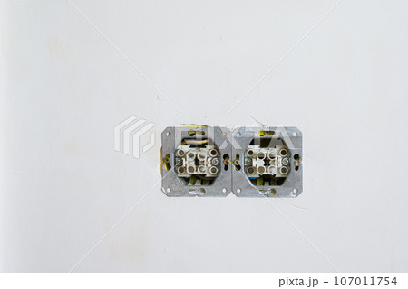 Double open electrical socket on a grungy gray wall. Double open electrical socket on a grungy gray wall. 107011754
