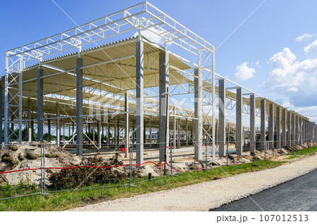Unfinished warehouse steel frame structure on reinforced concrete supports, corrugated steel roof Unfinished warehouse steel frame structure on reinforced concrete supports, corrugated steel roof 107012513
