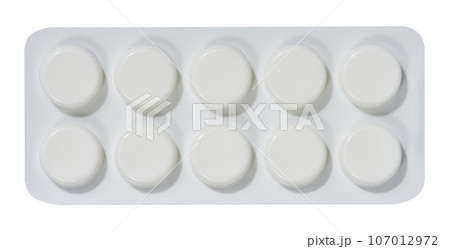 Round tablets in white plastic packaging, top view 107012972