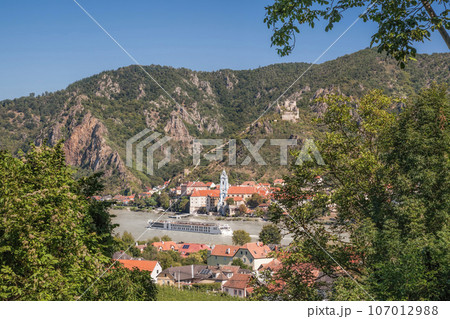 Panorama of Wachau valley (Unesco world heritage site) with ship on Danube river against Duernstein village in Lower Austria, Austria 107012988