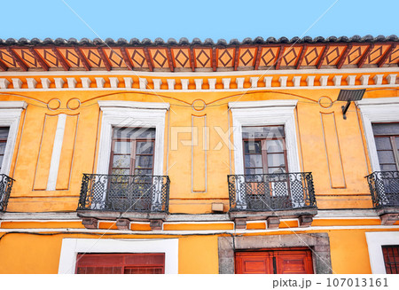 Street view of the facade of an old colonial building, Quito, Ecuador. Street view of the facade of an old colonial building, Quito, Ecuador. 107013161