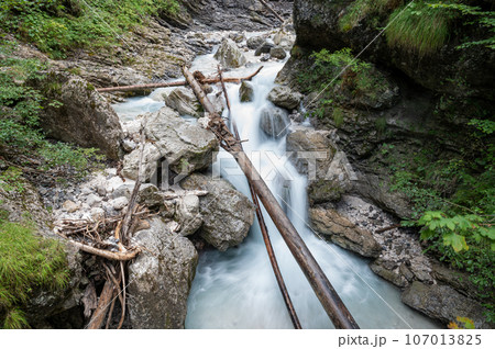 Beautiful mountain stream flowing through green mossy rocks Beautiful mountain stream flowing through green mossy rocks 107013825