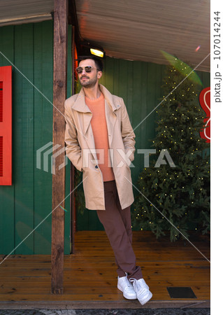 Man wearing sunglasses posing outdoors 107014244