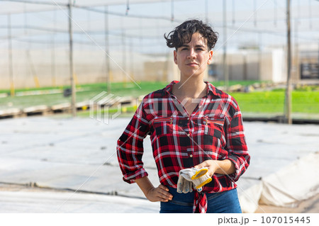 Portrait of woman gardener in hothouse Portrait of woman gardener in hothouse 107015445