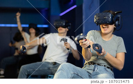 Happy woman is fascinated by movie in virtual reality glasses in room Happy woman is fascinated by movie in virtual reality glasses in room 107015475