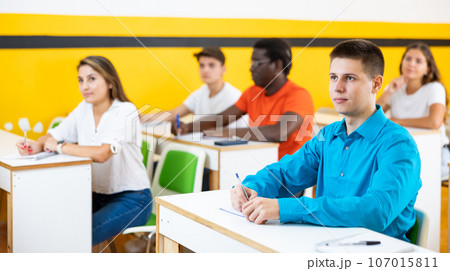 Teenage boy studying in taxi driving school Teenage boy studying in taxi driving school 107015811