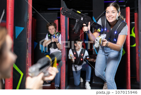 Young woman playing lasertag in arena 107015946