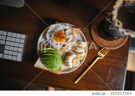 Coffee and breakfast on the desk Coffee and breakfast on the desk 107017563