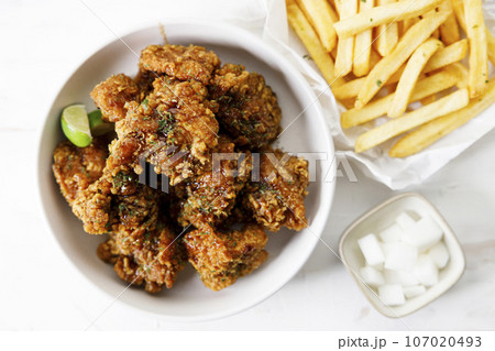Fried chicken with soy sauce in Korean style with pickled radish. Fried chicken with soy sauce in Korean style with pickled radish. 107020493