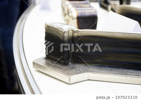 3d printed metal model close-up. Model printed on a 3D printer made of metal. Three-dimensional metal object created by a 3d printer from metal. 3D printing additive modeling manufacturing technology 107023310