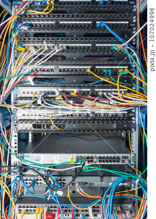 Detail of server with patch cables plugged in ethernet ports 107024996