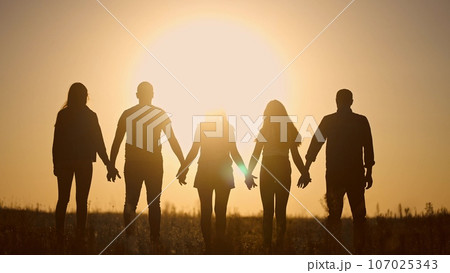 teamwork. team community a holding hands together silhouette at unity sunset. group of people hands. teamwork of workers. team in lifestyle the company running partnership business community hand 107025343