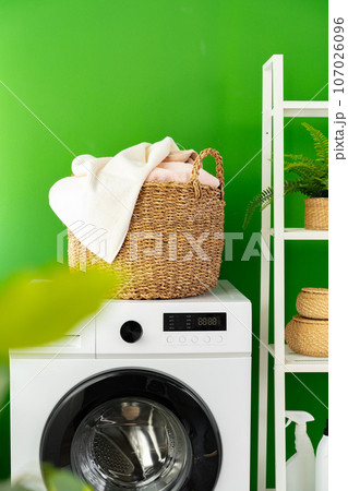 Laundry basket on washing machine in a laundry room 107026096
